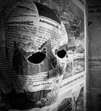 An eerie mask covered in newspaper