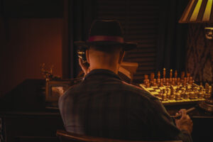 a man dressed in mafia-style clothes calling on a telephone